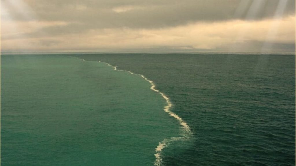 A stunning perspective on two oceans meeting with a noticeable limit, exhibiting their differentiating tones and properties.