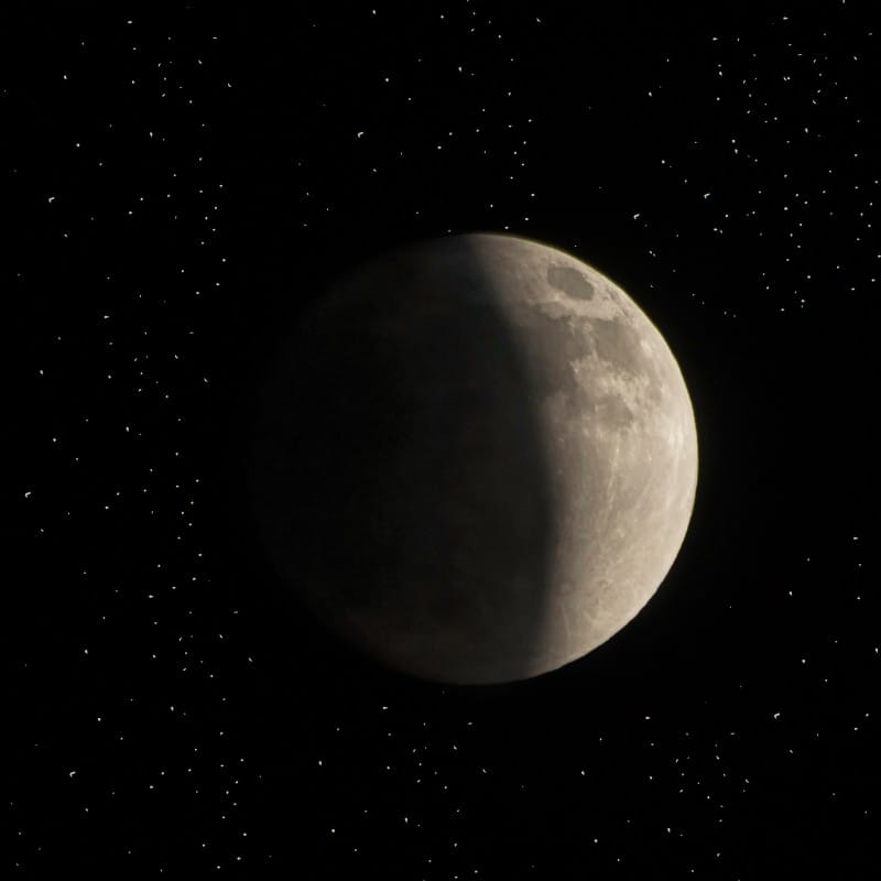 Unexplained Events 2026: high-contrast photograph of a gibbous moon with a sharp terminator line against a starfield